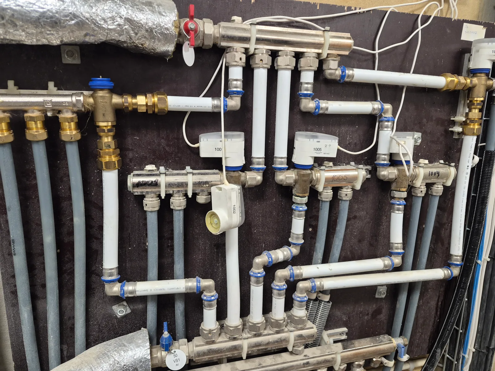Fördelarskåp för tappvatten med märkta avstängningar och rör-i-rör-installation